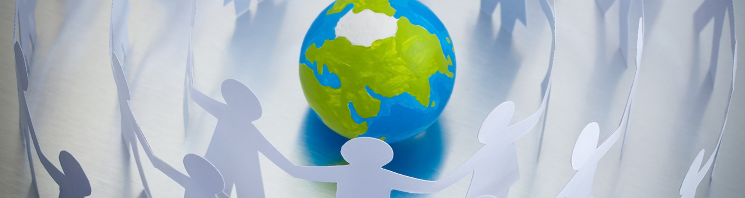 Paper figures join hands around globe. © Grondin Franck Olivier | Dreamstime Images