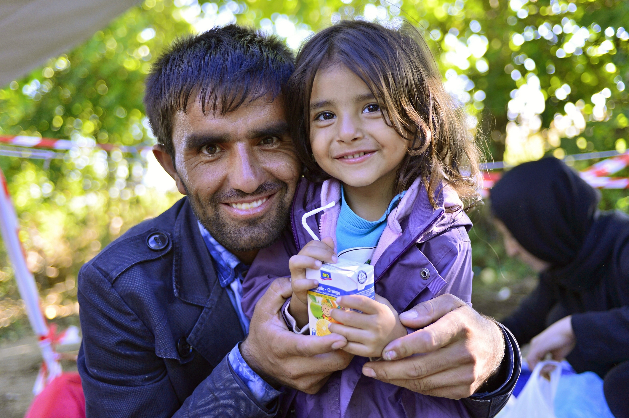 Hopeful refugee father holds his young daughter (Serbian - Croatina border).