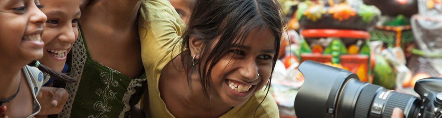East Indian girls on a city street are enjoying being photographed. © Jayv | Dreamstime Images