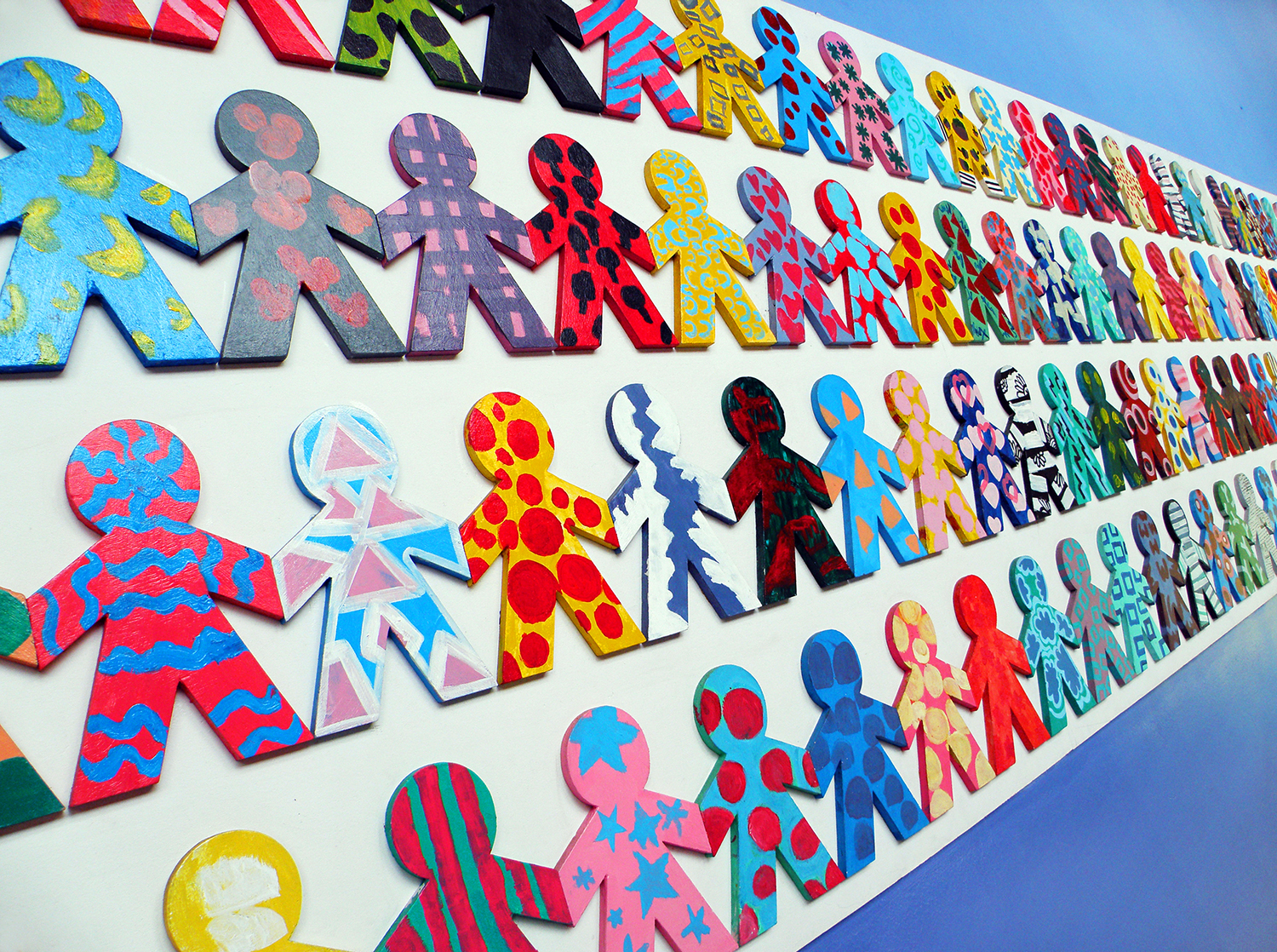 Multi-colored cutouts of children holding hands, symbolizing the diversity and unity of the world's people.