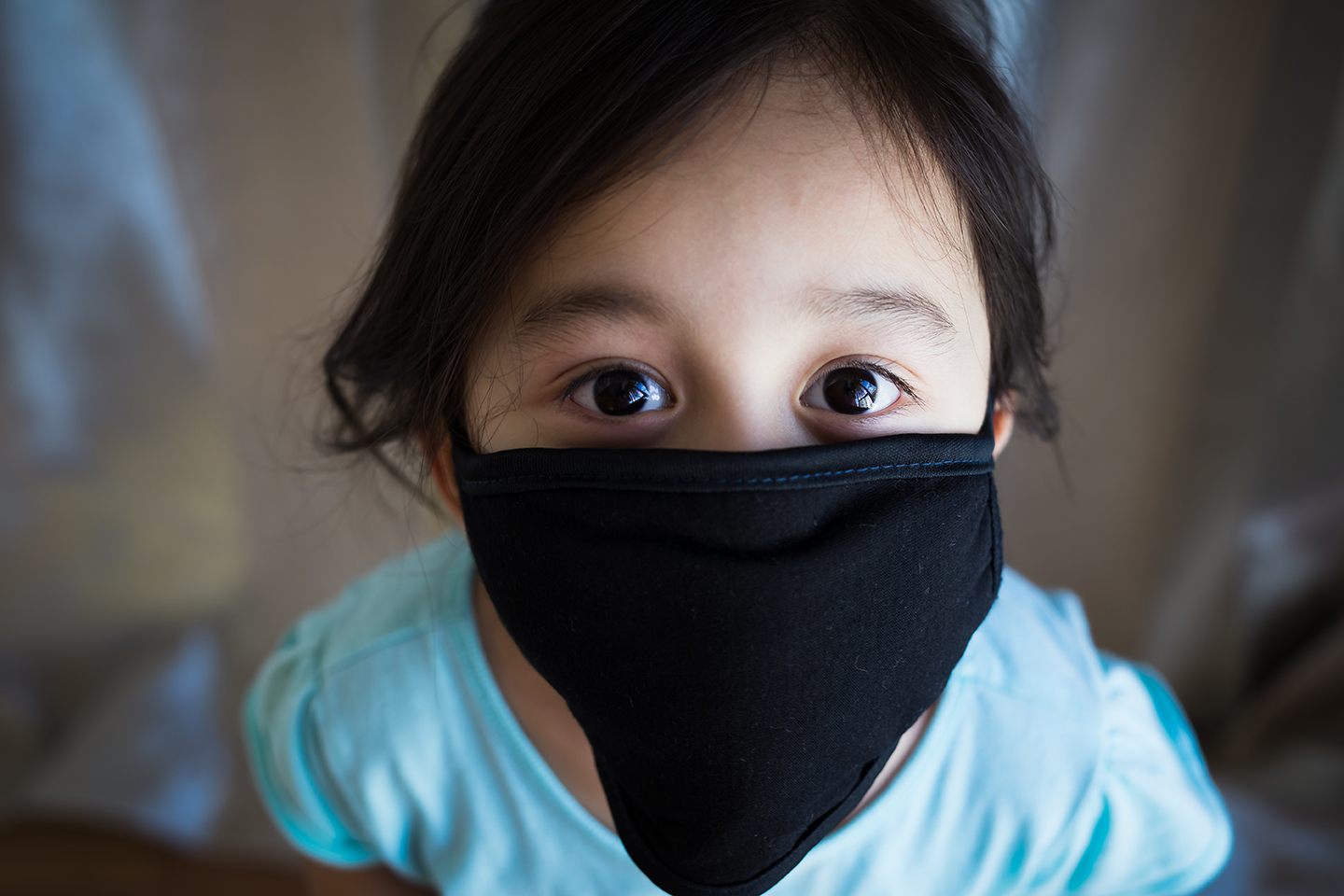 Asian toddler girl wearing a black Covid-19 protection mask. (123rf images/ellinnur)