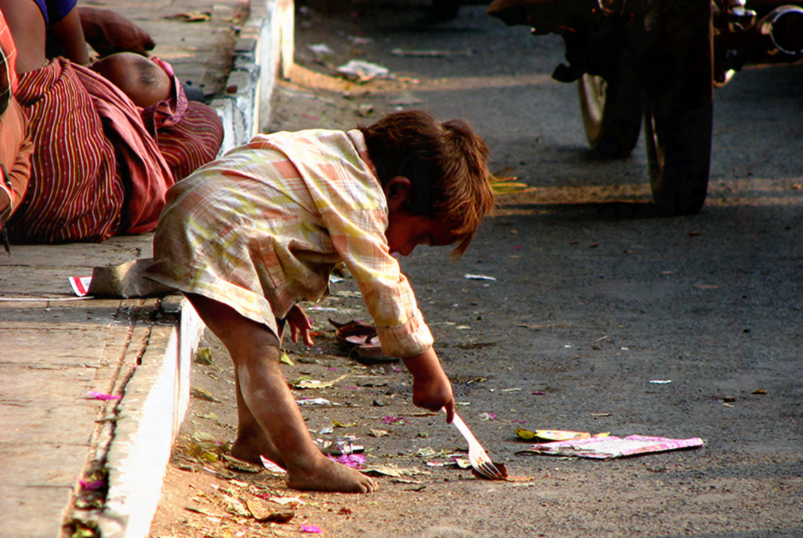 Homeless child searching for food on the side of a street. © Nikhil Gangavane, Dreamstime Images