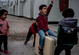 Seven-year old Louay, six-year old Ayman, six-year old Manena and six-year old Wael play with a suitcase that they found in the garbage at the Skaramagas refugee camp, in the port area of northern Athens, Greece. © UNICEF/Gilbertson VII  