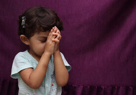 Young girl in prayer. Photo 231671152 / World Day © Grower More | Dreamstime.com