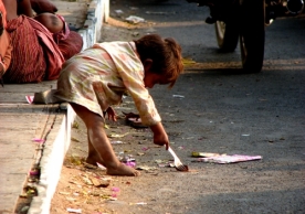 Homeless child searching for food on the side of a street. © Nikhil Gangavane, Dreamstime Images