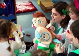 A Wheelock College student plays with children in a Belfast classroom during a service-learning trip to Northern Ireland. 
