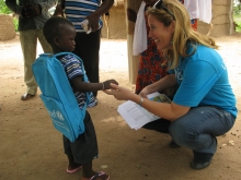 Christina de Bruin greets young boy in Côte d’Ivoire, Ivory Coast.