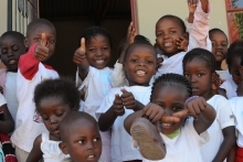 Refugee school children in South Africa give thumbs up. 