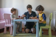 Father and his two children engage in artwork (Turkey).