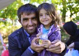 Hopeful refugee father holds his young daughter (Serbian - Croatina border).