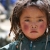 A lovely little Tibetan girl with plateau-red cheeks. 