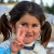 Syrian girl in refugee camp (Suruc, Turkey) holds peace hand sign. 