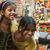 East Indian girls on a city street are enjoying being photographed. 